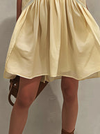 Yellow Sleeveless Mini Dress with Deep V-Neck and Lace Trim